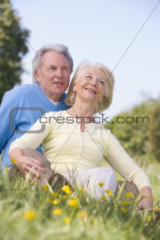 Couple relaxing outdoors smiling
