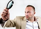 male with magnifying glass