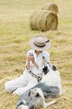 Farm Girl Relaxing with her Dog