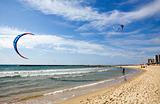 Two kitesurfers on the beach at Tel-Aviv