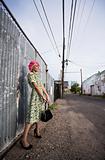 Woman with Pink Hair and a Purse in an Alley