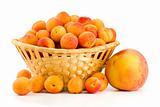 Wicker basket filled with apricots and single peach near