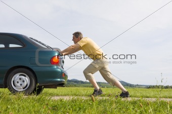 Man pushing his car