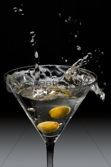Dropping olives into a martini