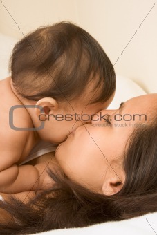 Mother kissing her baby boy son