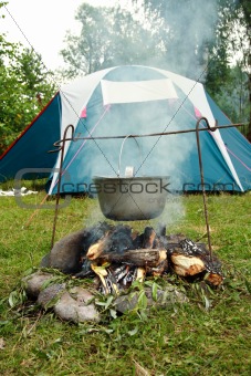 tent and saucepan on a fire