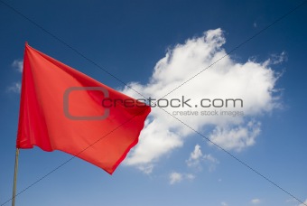 Red flag on blue sky with clouds!