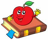 Smiling apple on book