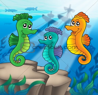 Sea horses family with shipwreck