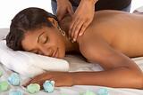 African-American woman getting massage in spa