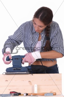 woman carpenter at work, sander