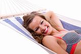Sexy woman wearing bikini relax on hammock 