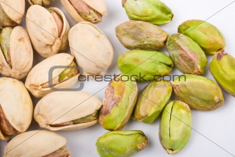 Several pistachio nuts naked and in shell close up