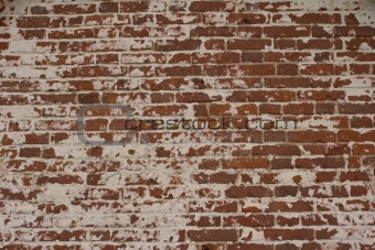 Old brick wall with remains of plaster