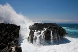 Ocean waves crushing against cliff