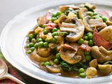 Mushroom and Pea Curry with Roasted Garlic on a Pewter Plate