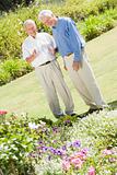 Senior men standing in garden
