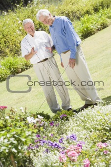 Senior men standing in garden
