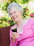 Senior woman enjoying glass of wine