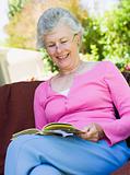 Senior woman reading book outside