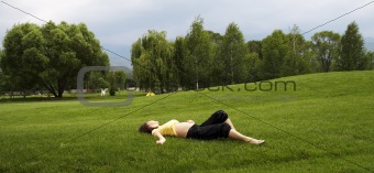 Girl lie on green grass