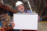 worker in uniform carrying box in warehouse