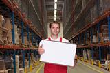 worker in uniform carrying box in warehouse