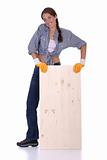 woman carpenter holding wooden plank