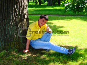 Young man near to a tree