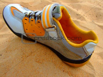 Sports boot on sand.