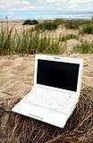 White small Laptop on the beach