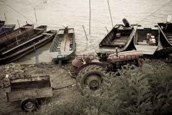 vintage tractor and traditional fishing boats