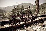 rusting railroad bicycle next to rail tracks