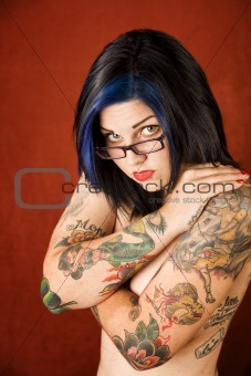 Woman with tattoos and crossed arms