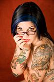 Woman with tattoos and crossed arms