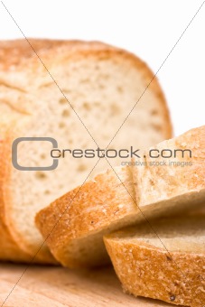 Sliced bread on wooden plate