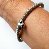 The Silver bracelet-spring with heart on hand.