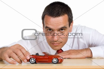 Businessman with toy car - isolated