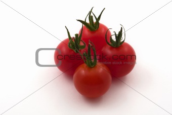 Four cherry tomatoes on white