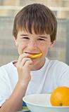Boy Eating An Orange Slice