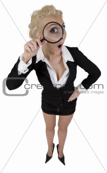 young curious woman holding detective magnifying glass enlarging her eye