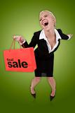 Beautiful  woman with a  sale shopping bag on isolated green