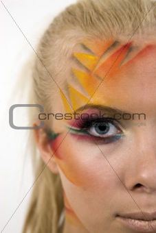 Close up of pretty young woman with creative artistic makeup.