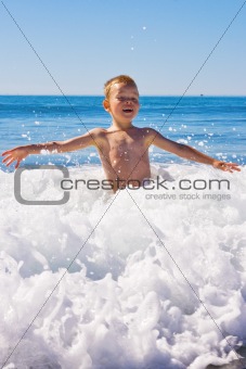 Child playing in the sea