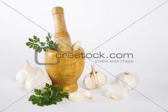 Mortar and pestle with garlic and parsley