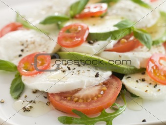 Tomato Avocado and Mozzarella Salad with Olive Oil and Black Pep