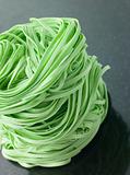 Stack of Spinach Noodles on a Black Background