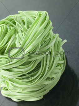 Stack of Spinach Noodles on a Black Background