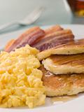 American Pancakes with Crispy Bacon and Scrambled Eggs and Maple