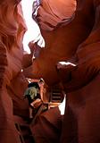 young woman hiking in slot canyon
